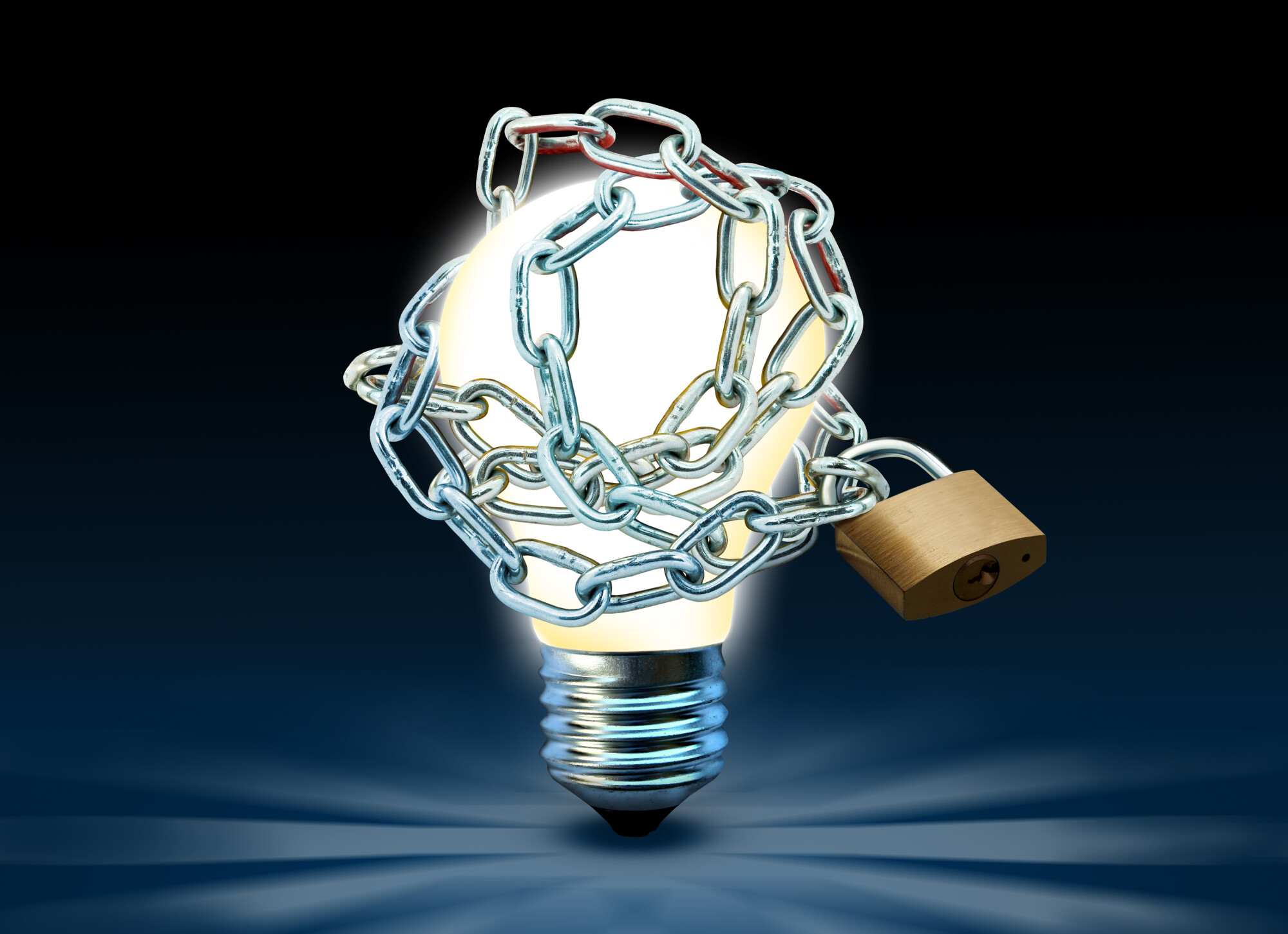 Glowing lightbulb with chain and padlock. Idea is locked and restrained conceptual theme.