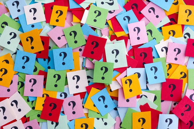 Multiple stick notes, all different colors, with question marks scribbled.